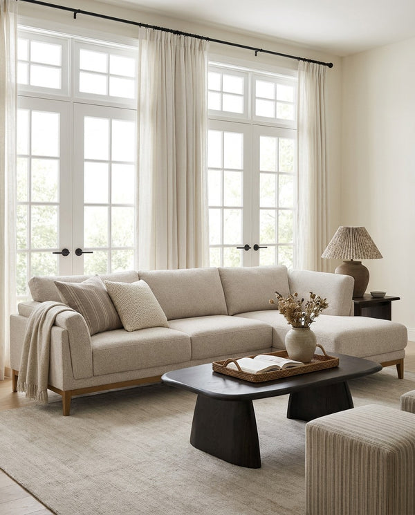 Upholstered Liva Sectional sectional sofa in Natural Dune in a living room with natural light