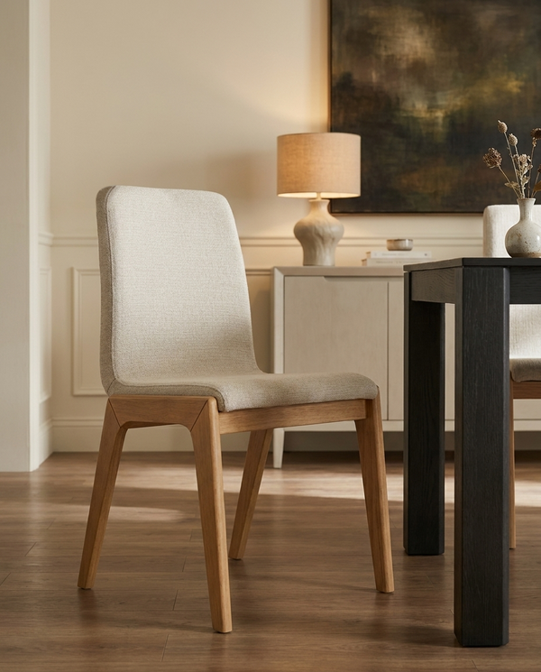 Upholstered Tova Dining Chair around a dining table