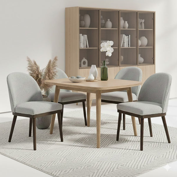 Upholstered Saville Dining Chair around a dining table