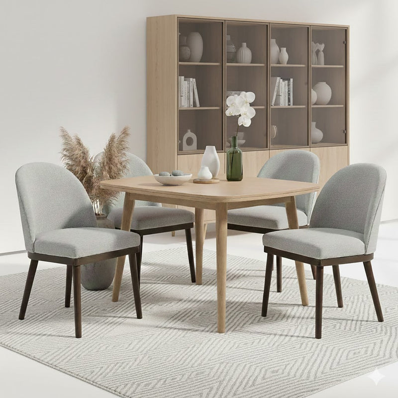 Upholstered Saville Dining Chair around a dining table