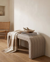 Arc Bench Large in Hazelnut Cream boucle, styled with stacked books and a folded throw