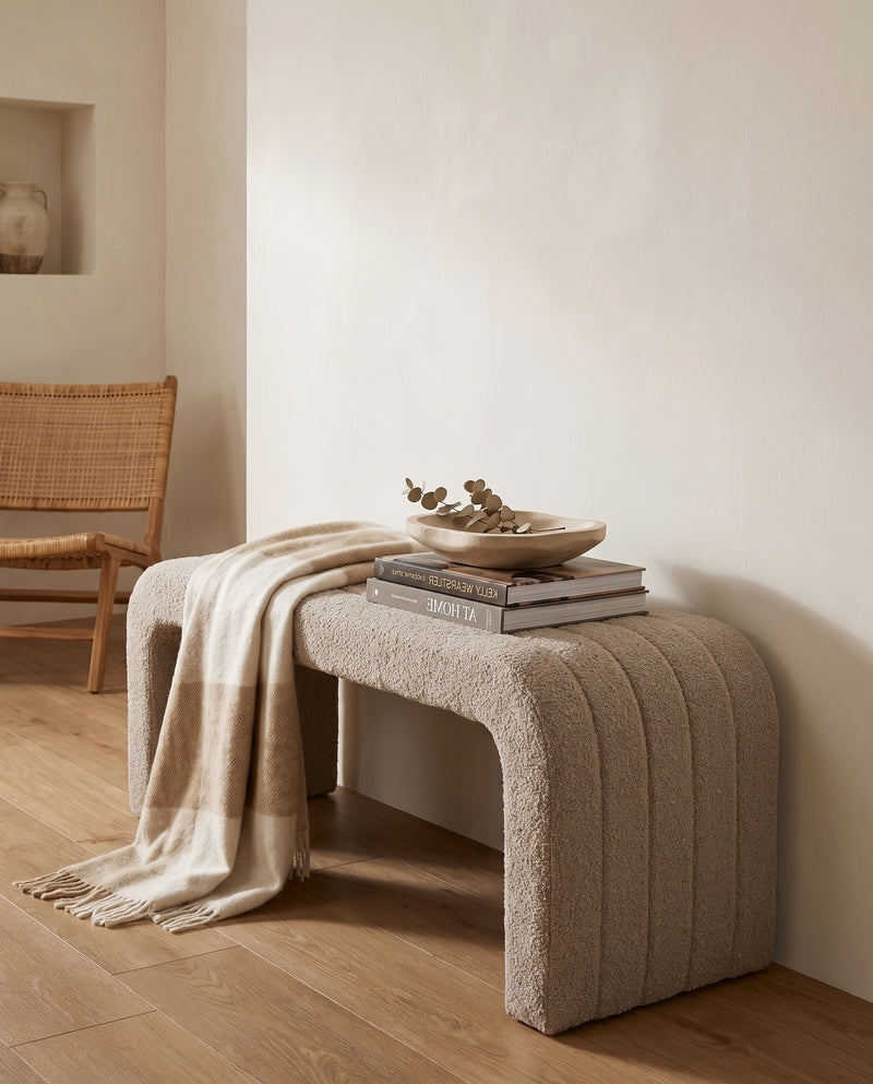 Arc Bench Large in Hazelnut Cream boucle, styled with stacked books and a folded throw