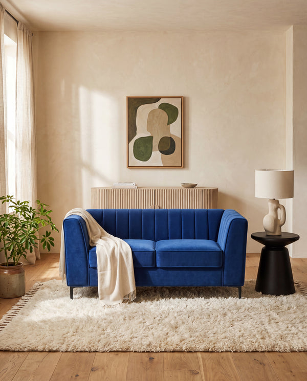 Enigma Loveseat in Blue Velvet styled in a living room