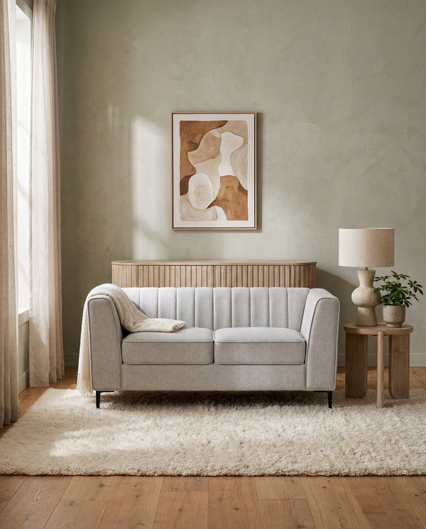 Enigma Loveseat in Oyster styled in a living room