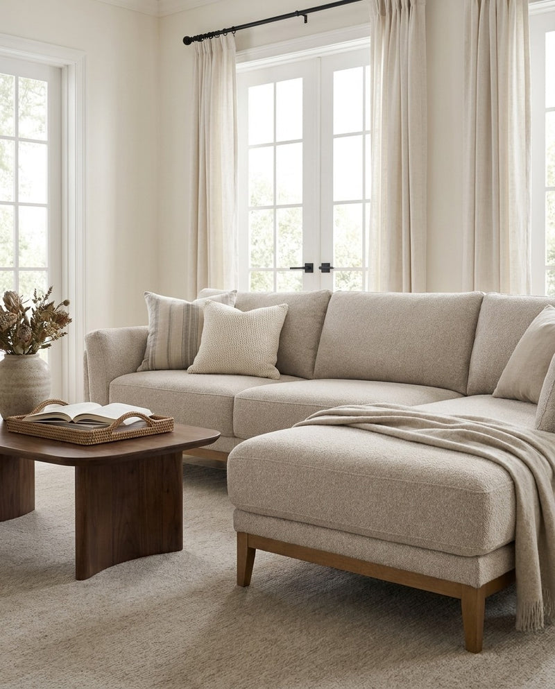Upholstered Liva Sectional sectional sofa in Natural Dune styled with a coffee table