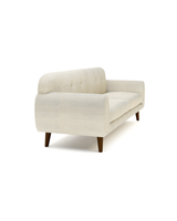 Upholstered Calia Sofa, three-quarter view with tufted back