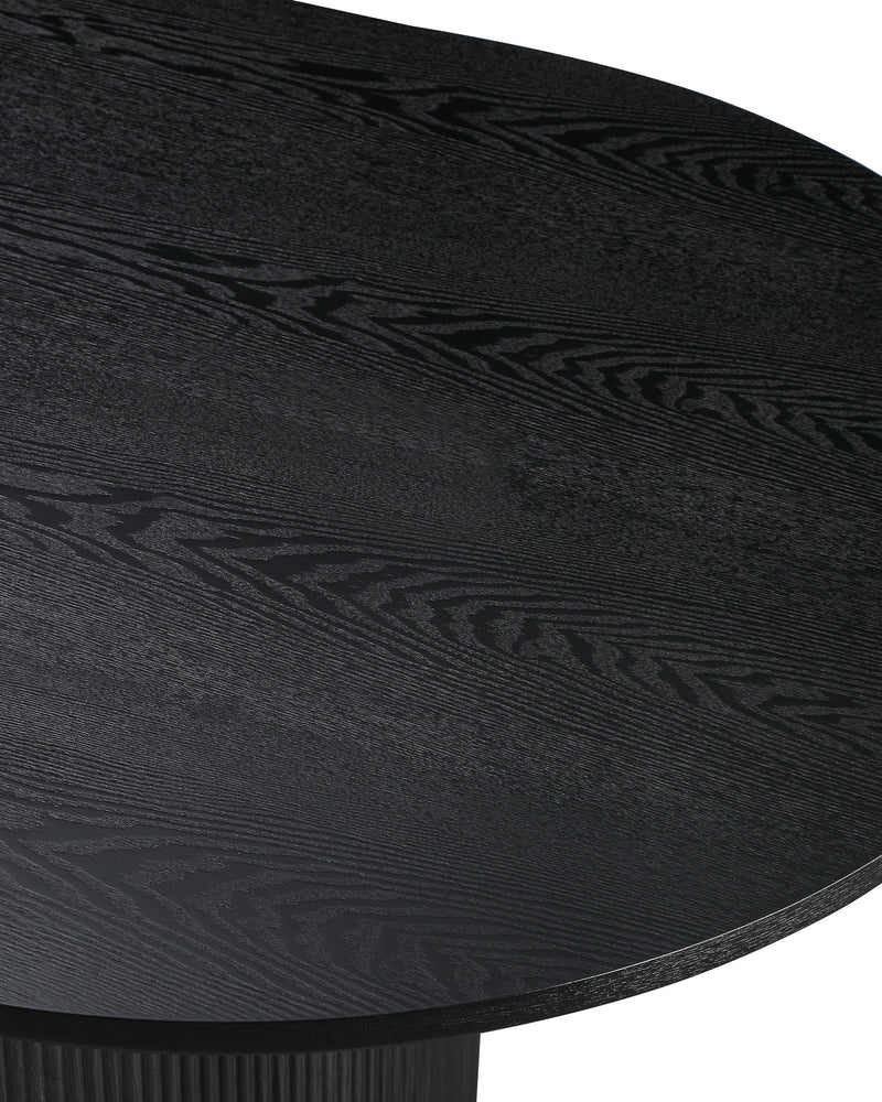 Close-up of the tabletop edge and fluted base on the Cydra Dining Table in Slate