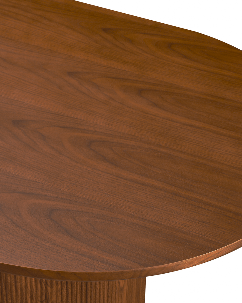 Close-up of the tabletop edge and fluted base on the Cydra Dining Table in Walnut