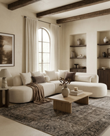 Aykah Elaan Sectional in White Chocolate, styled in a living room with open shelving