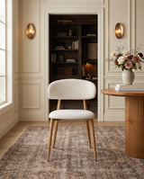 Bouclé Mabel Dining Chair with Oak-finish metal legs, single chair on a patterned rug in a panelled dining room