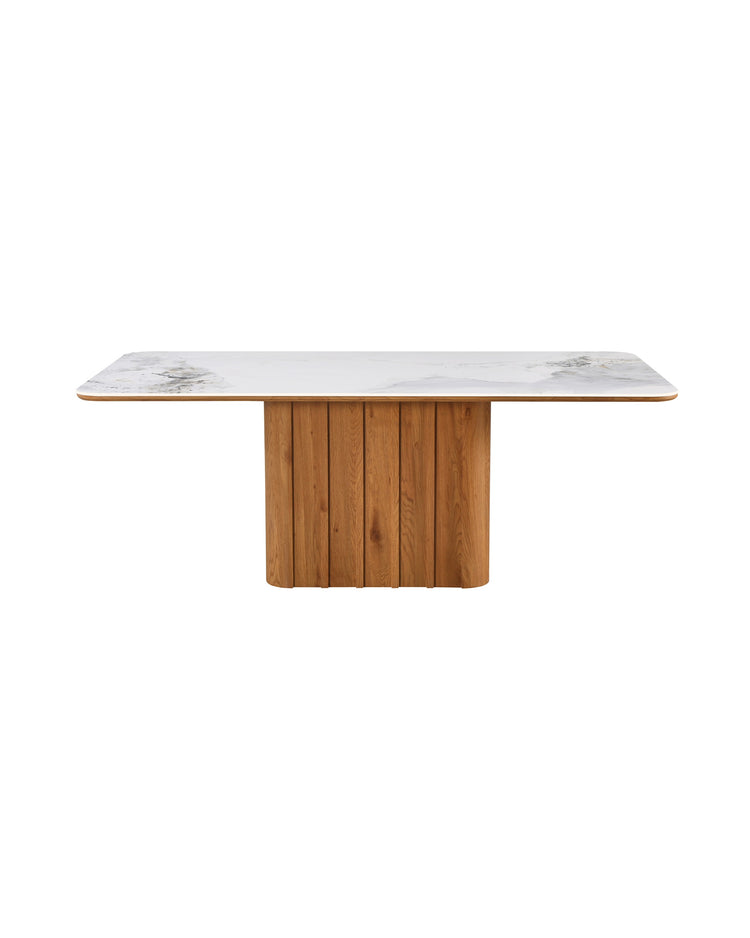 Aykah marble-look Sylas Dining Table in Honey Oak, front view with fluted pedestal base